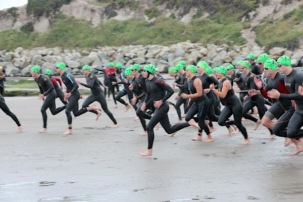 Image of triathletes running for the water